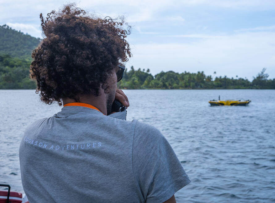 A surface officer looks out at a submersible preparing to dive