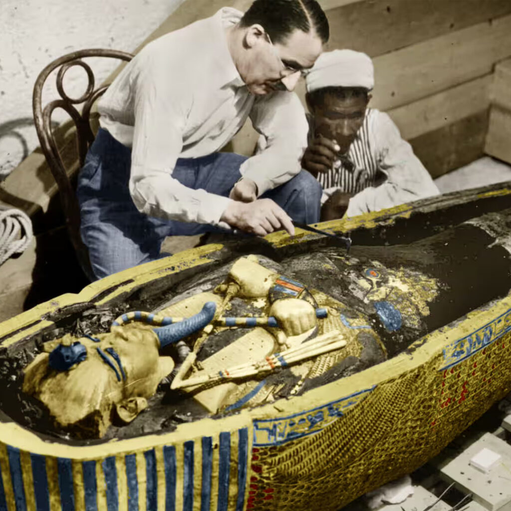 Egyptologist inspecting a mummy with assistant