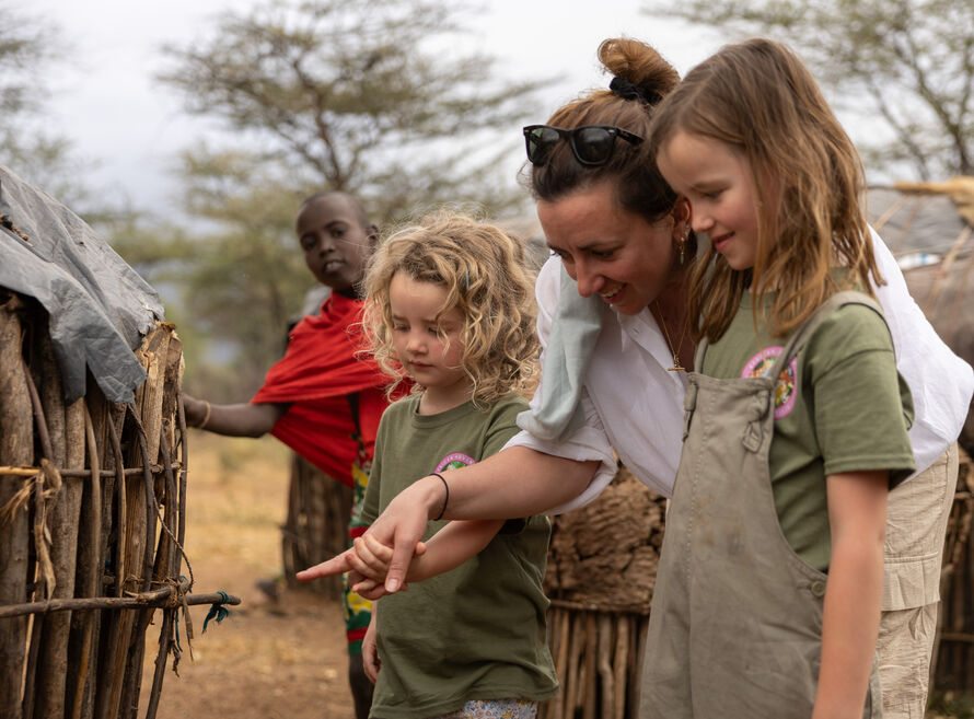 Girls being shown around tribal village