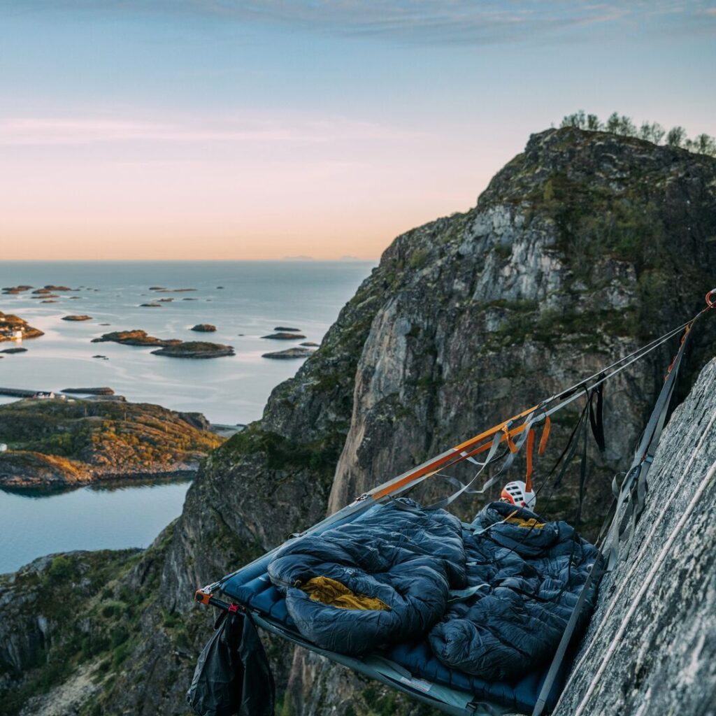 Portaledge hanging on a cliff face looking out onto the ocean