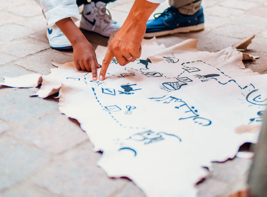 Child pointing at treasure map