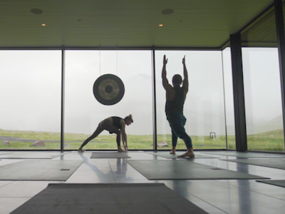 Couple doing yoga in a glass room