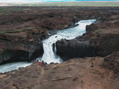 Drone shot of waterfall and people