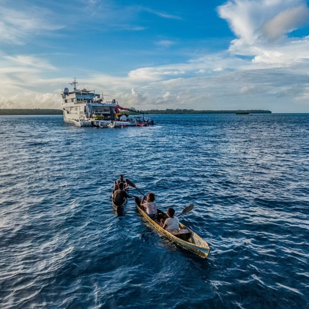 Explorer yacht with dugout canoe