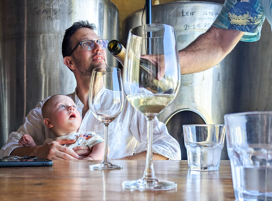 Father with child, being served wine