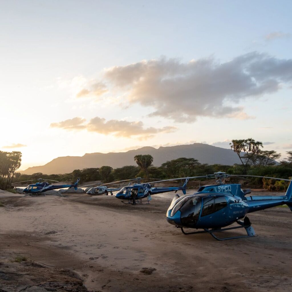 Fleet of helis in Kenya by a dry riverbed