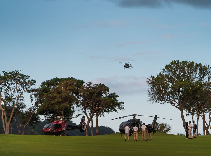 Helicopters landing on a golf course